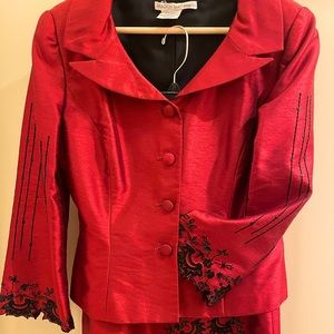 Red jacket and skirt with black sequin detail.